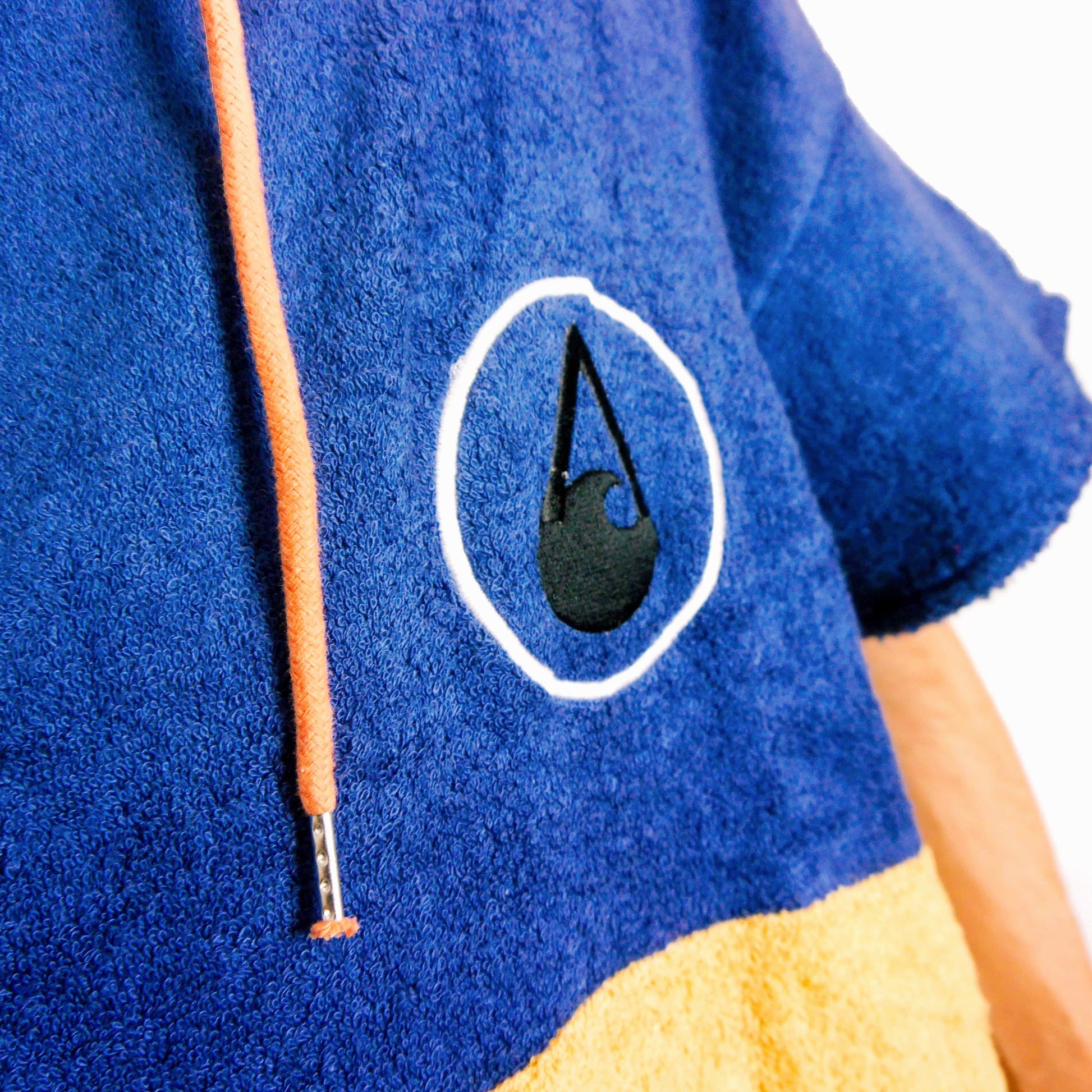 Wave Style Poncho FLOW Logo Close View